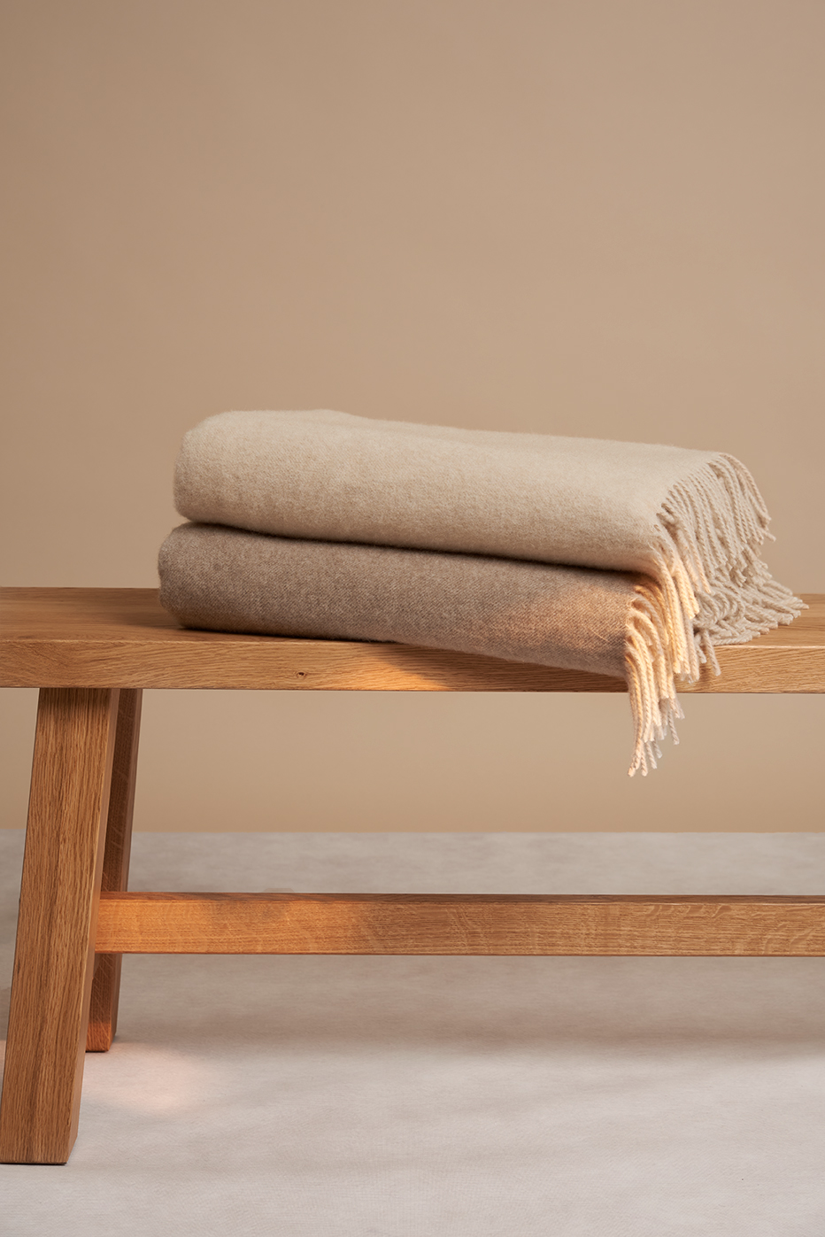 Blankets on a bench. Photographed by Studio Taupe