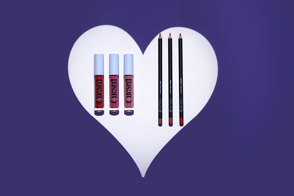 A set of 3 lipliners and lipsticks in a white heart surounded by purple.