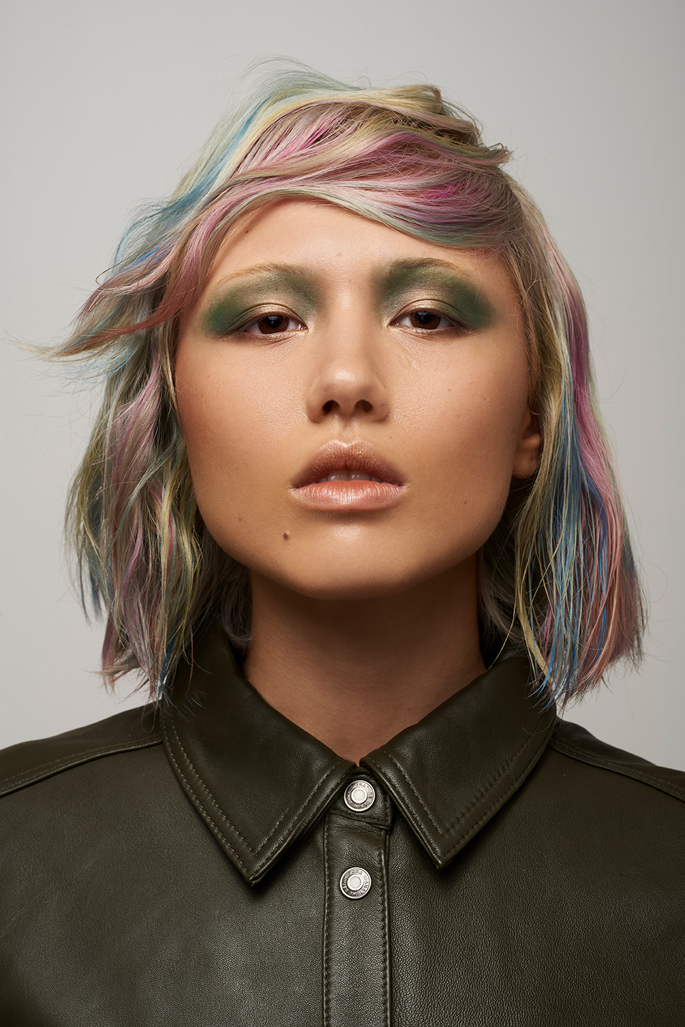 Model on a grey background with coloured hair.
