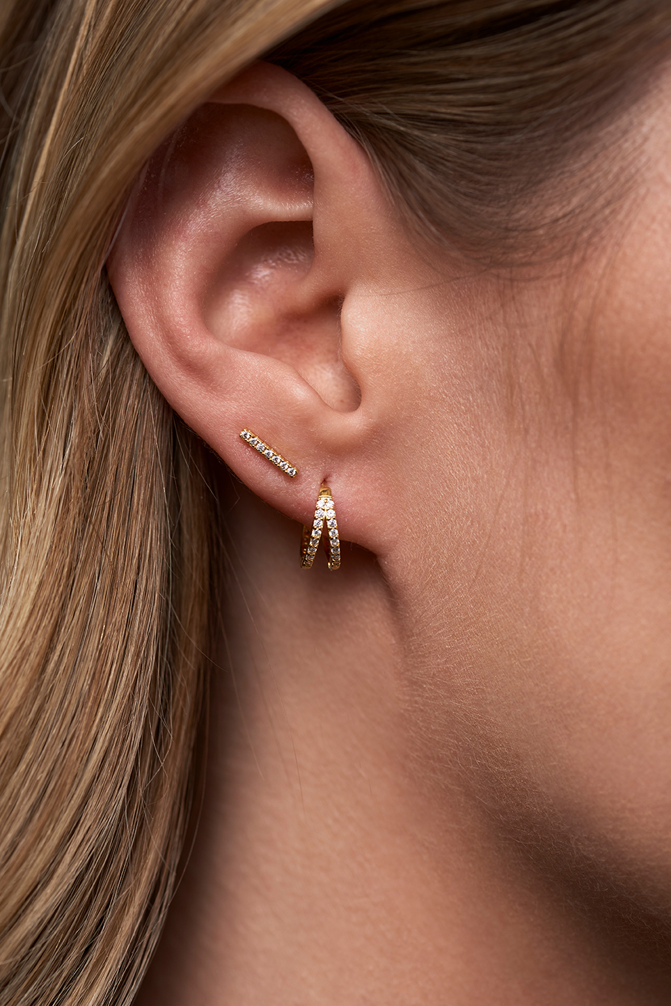 Lookbook photo of an ear with earrings in it.