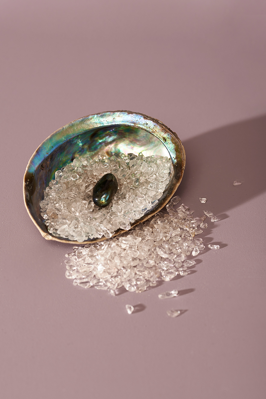 Product photo of a gemstone being placed in a shell to retain it's strenght.